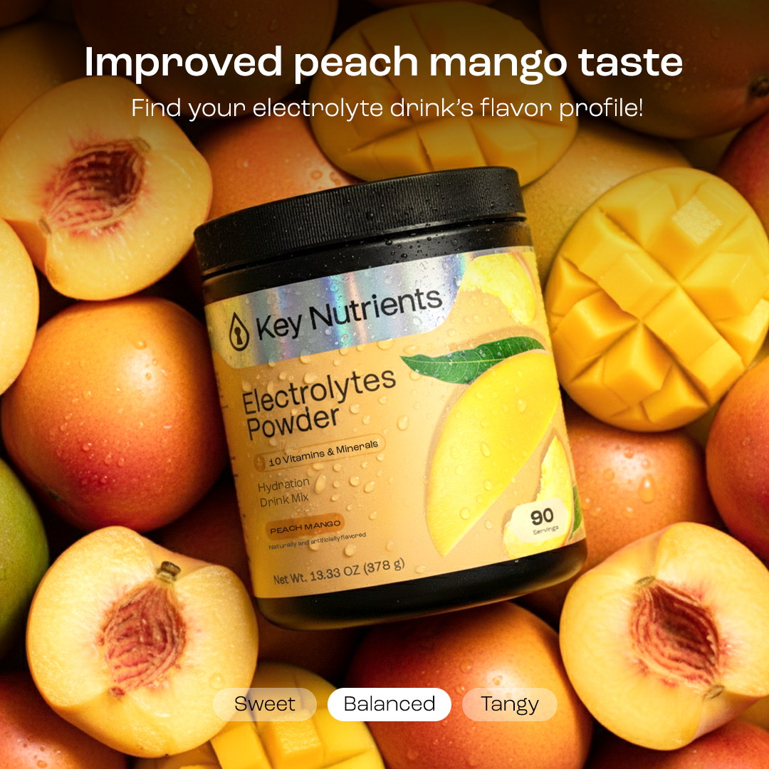 Sugar-Free Electrolyte Recovery Powder for Hydration in peach mango flavor next to fresh peaches and mangoes.