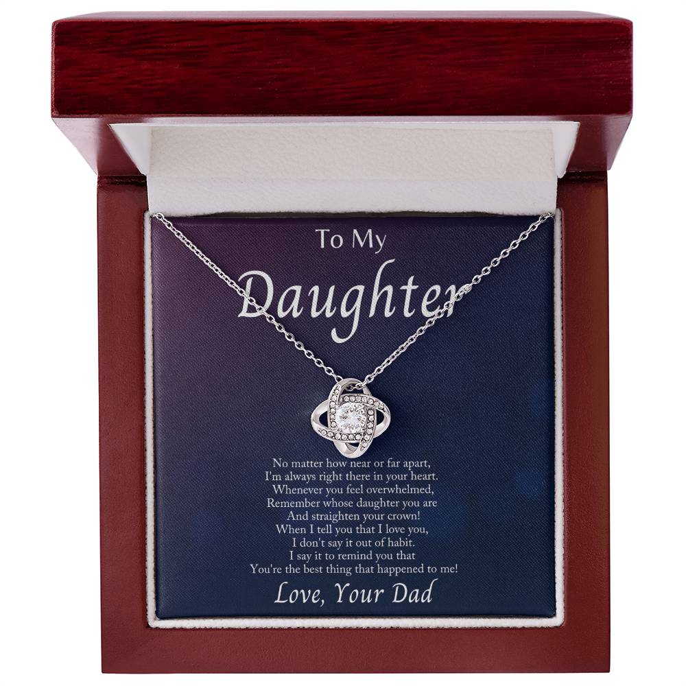 Close-up of a love knot necklace in a gift box with heartfelt message for daughter, featuring sparkling cubic zirconia.