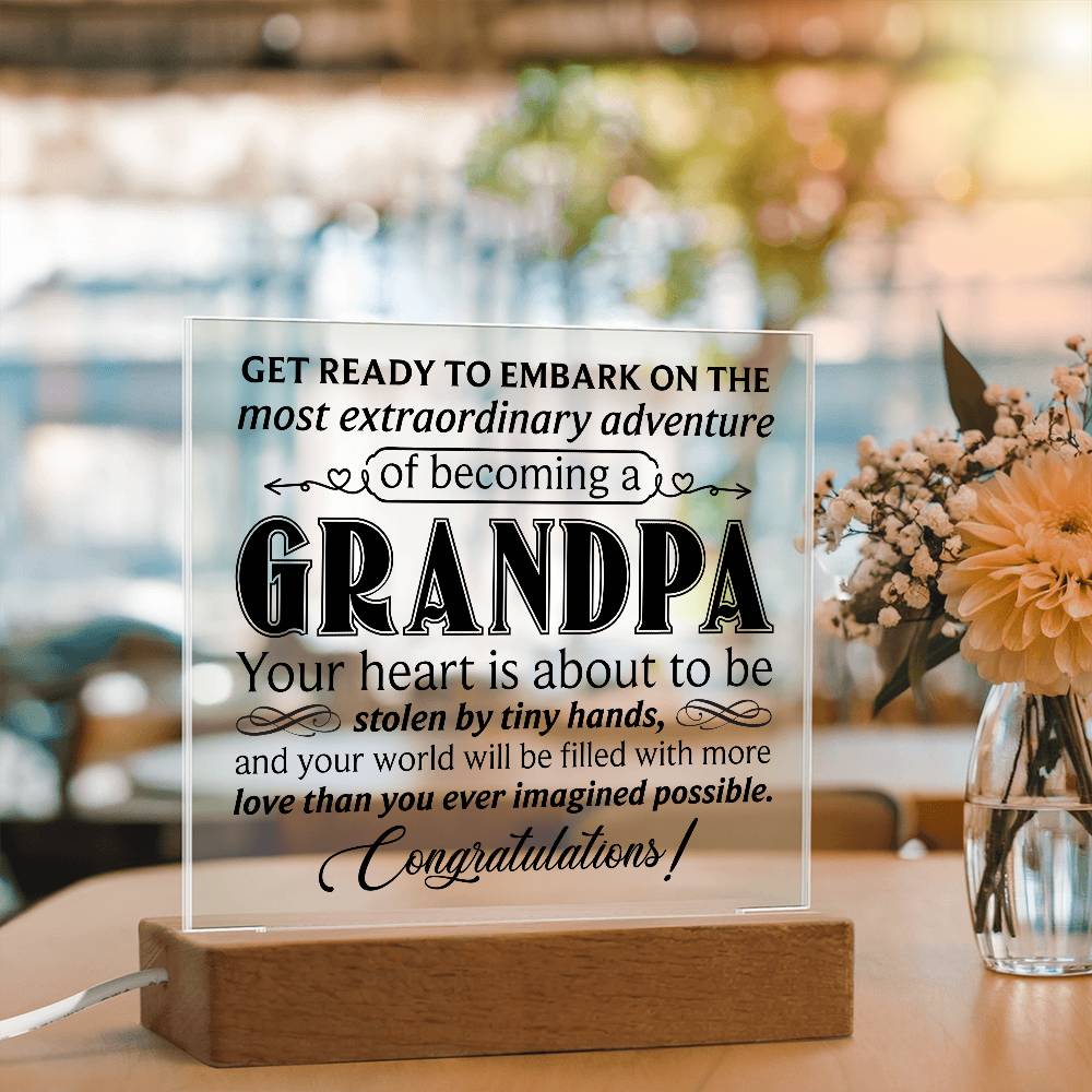 Acrylic square plaque featuring heartfelt message about becoming a grandpa, displayed on a wooden base.