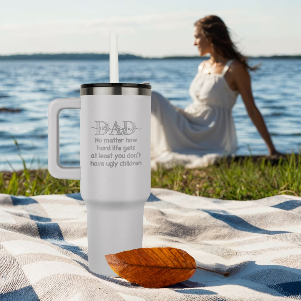 40oz stainless steel tumbler beside a woman in a white dress by the lake.