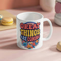 Custom ceramic coffee mug featuring the phrase 'Great Things Are Coming' with colorful floral design.