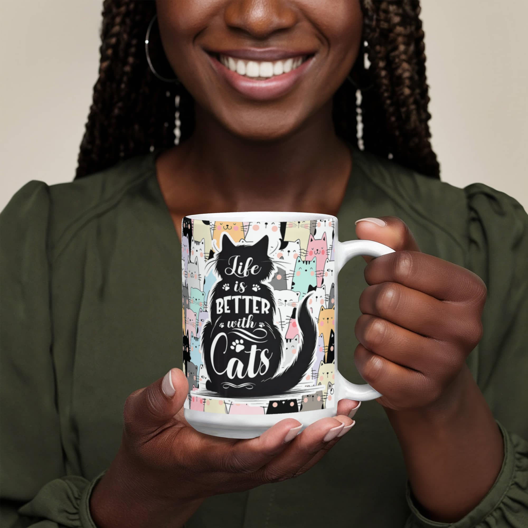 Woman holding a colorful Life Is Better With Cats mug, featuring cat illustrations and playful typography.